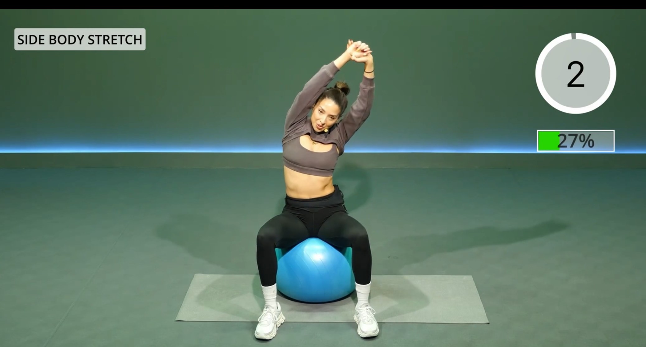 A Mat class in progress, showing the move name Side Body Stretch, a countdown timer and a progress bar